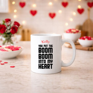 A personalised mug with retro text saying "you put the boom boom into my heart" from the Wham song, Wake Me Up Before You Go Go. Personalise the mug with a name or message.